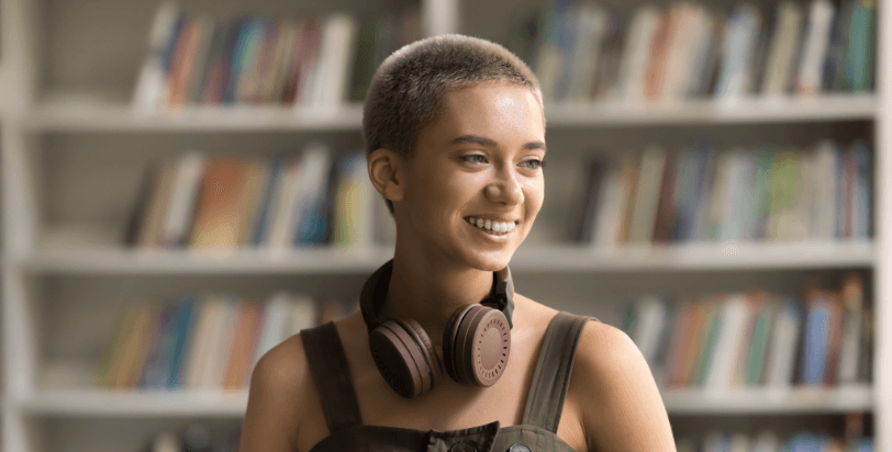 girl with headphones on in library
